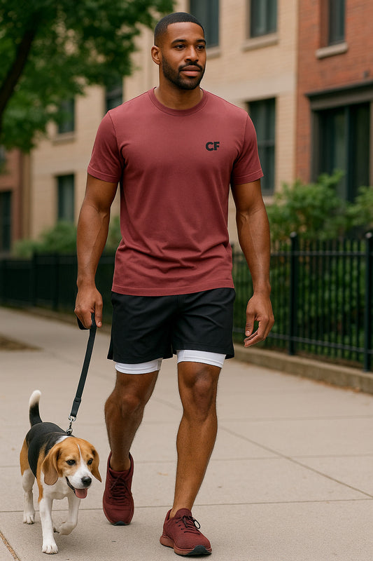 Man walking a dog on a leash wearing Black CoreFlex Shorts